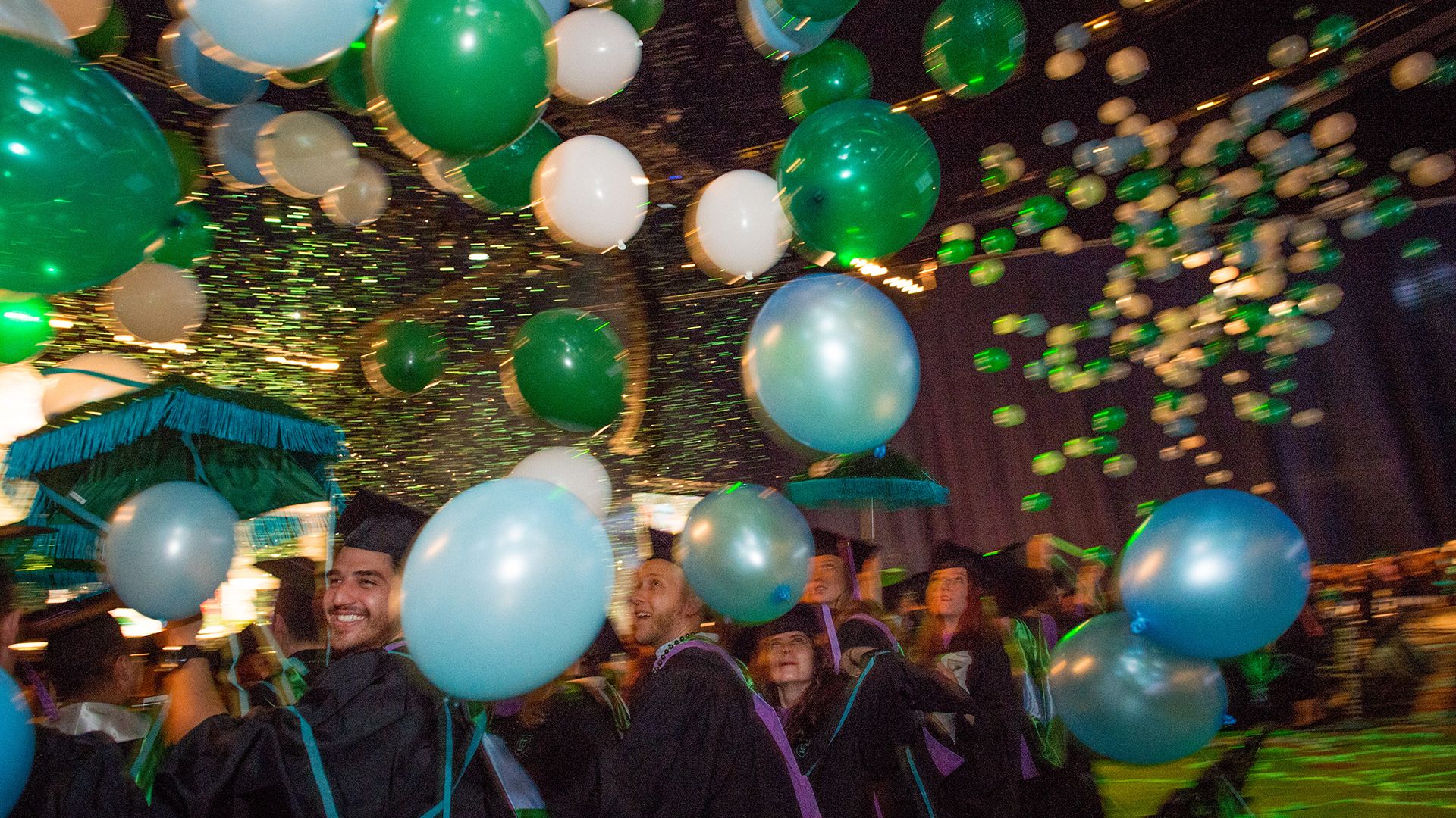Balloons rain down on graduates in the Mercedes-Benz Superdome