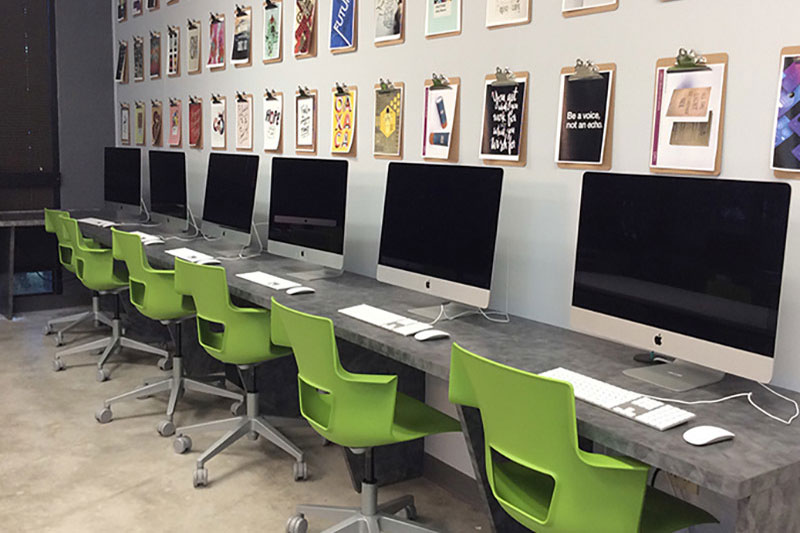 Digital lab with row of Mac desktop computers