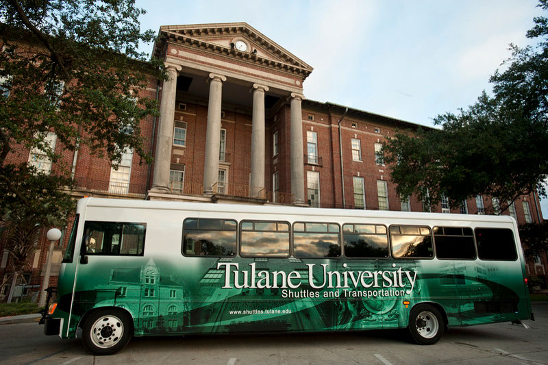 Tulane shuttle parked in front of building on the uptown campus