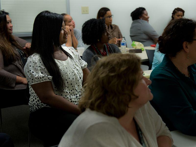 Staff members listen attentively during HR meeting