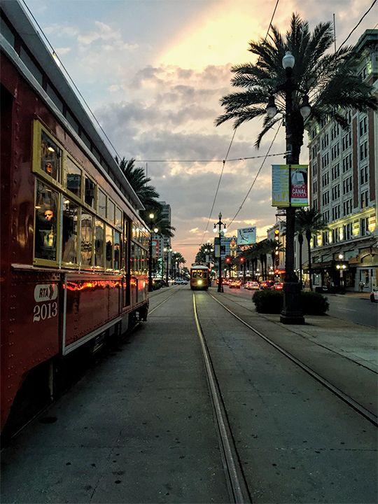 Streetcars on Canal Street at sunset