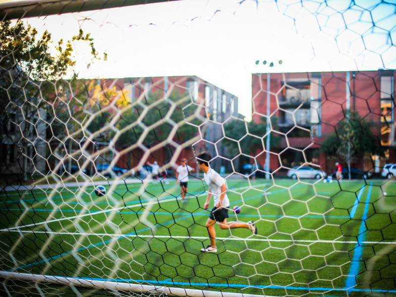 Students play soccer on campus quad