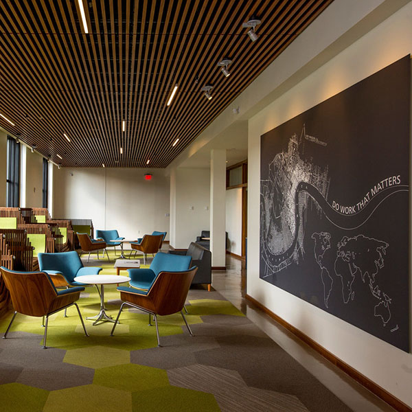 Lounge area near windows and large drawing of the Mississippi river on wall