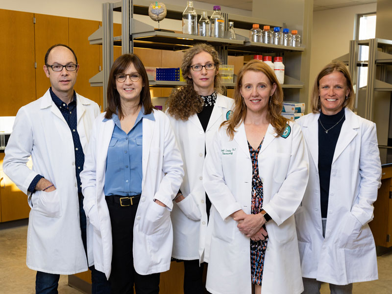 Brain Institute team pose for photo in lab