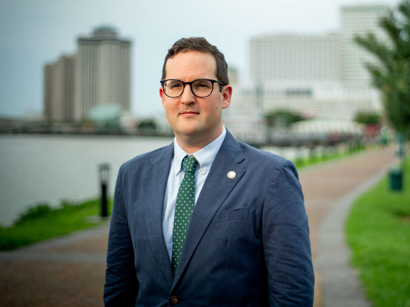 Jesse Keenan stands near riverfront