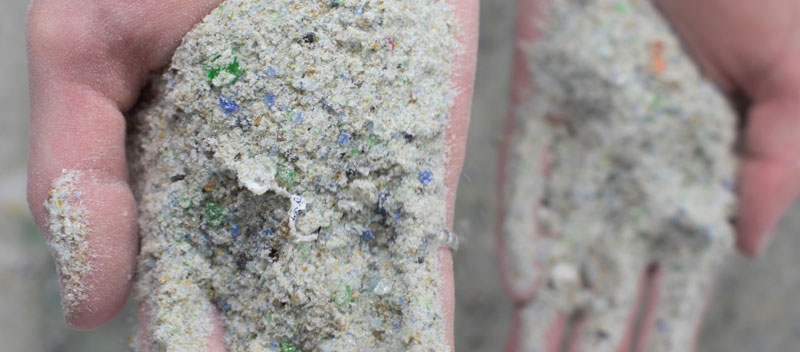 Two hands holding sand