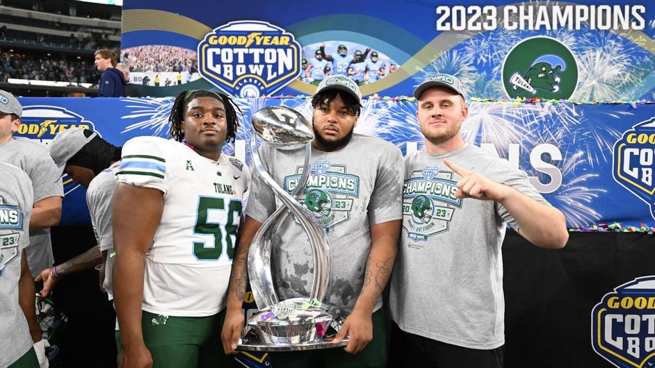 Tulane Football Athletes pose with their Cotton Bowl trophy.
