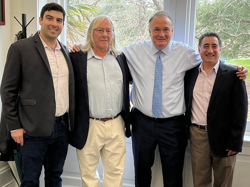 Tulane President Michael A. Fitts, second from right, celebrates the recent acquisition of Fluence Analytics by Japanese industrial giant Yokogawa.