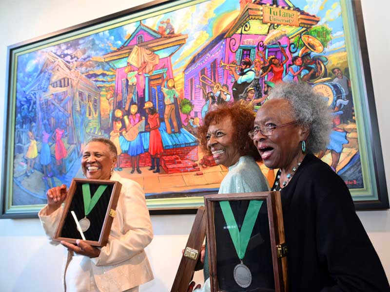 Marilyn Piper, Gloria Bryant Banks and Pearlie Hardin Elloie, the first African American graduate students to earn degrees from the Tulane School of Social Work and among the first to graduate from Tulane, stand in front of a commissioned portrait by renowned artist Terrance Osborne, honoring them as Tulane Trailblazers.