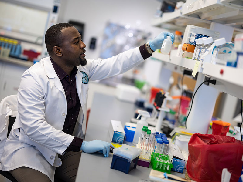 Graduate student Ferris Munyonho works in a lab at the School of Medicine.
