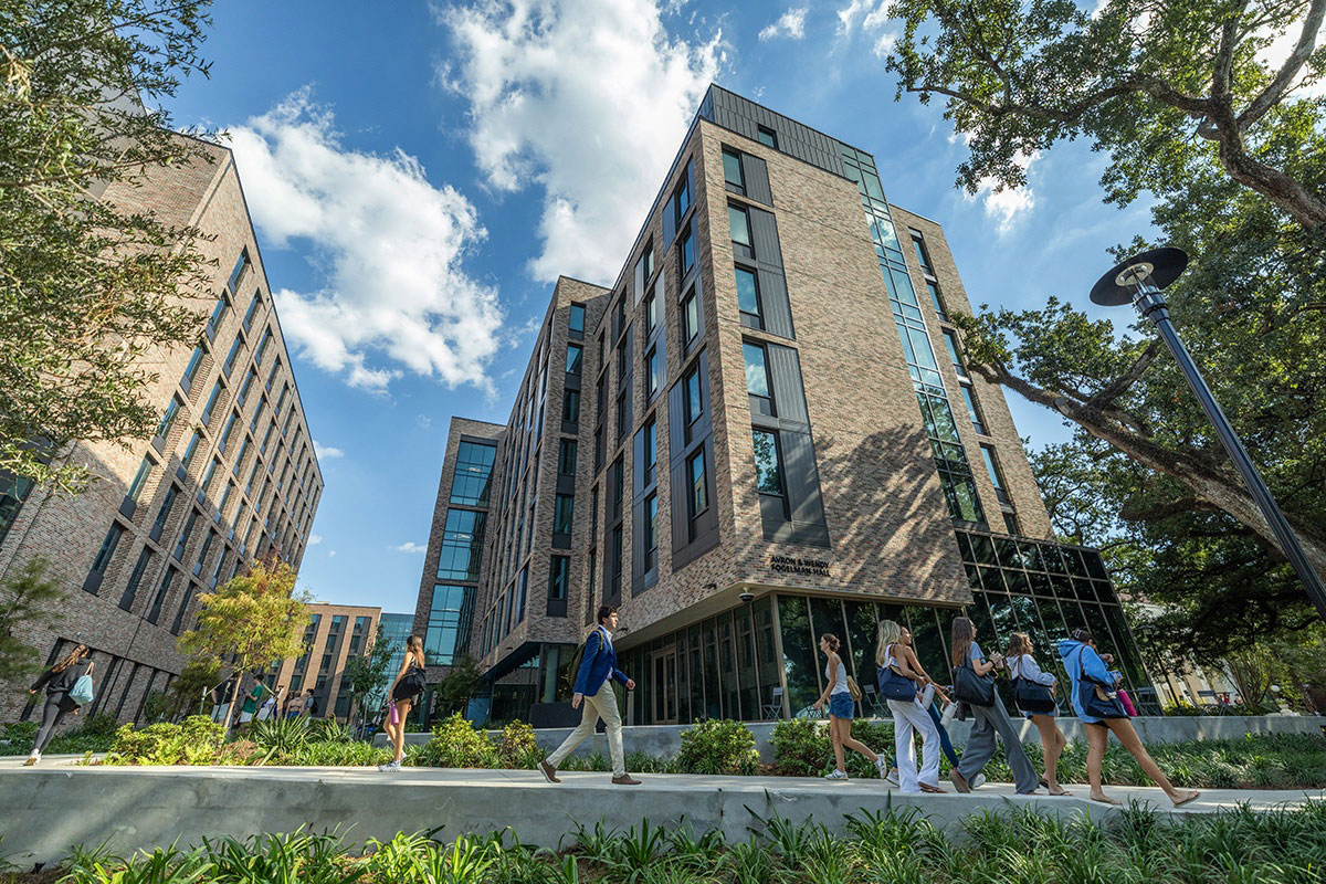 Students walk past Fogelman Residence Hall