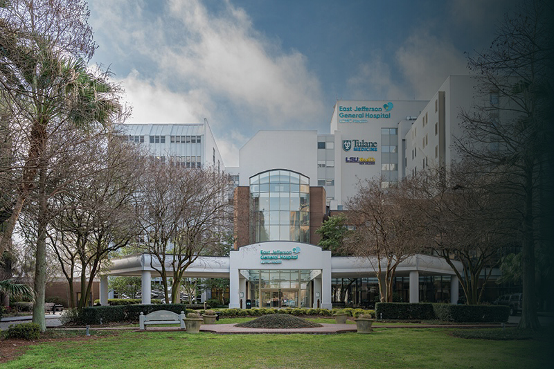 Photo of the Tallahassee Memorial HealthCare facility exterior, surrounded by trees.