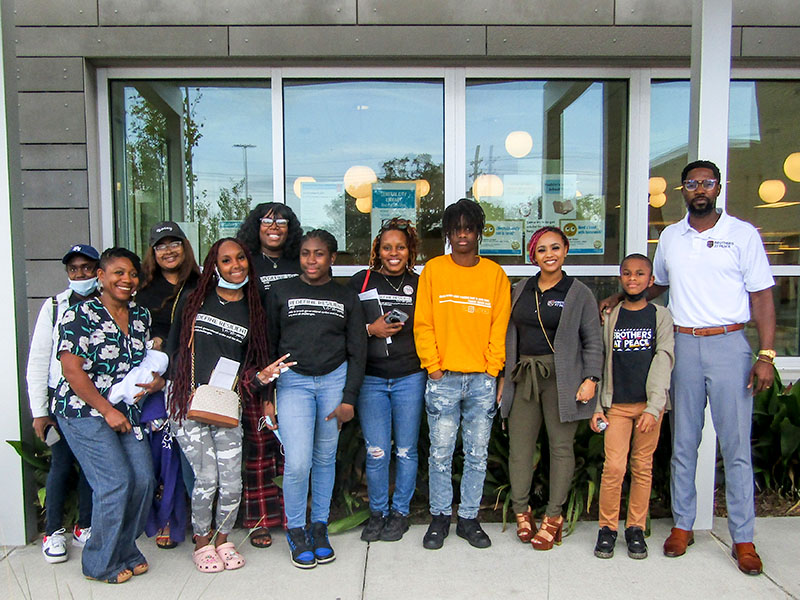 Samantha Francois (second from left), assistant professor of social work, Dominque Jones-Johnson (center), executive director of Daughters Beyond Incarceration, Tasia Taylor (third from the right), project coordinator for Brothers at Peace, and (far right) Ronald Scott, executive director of Brothers at Peace, pictured with youth mentees.
