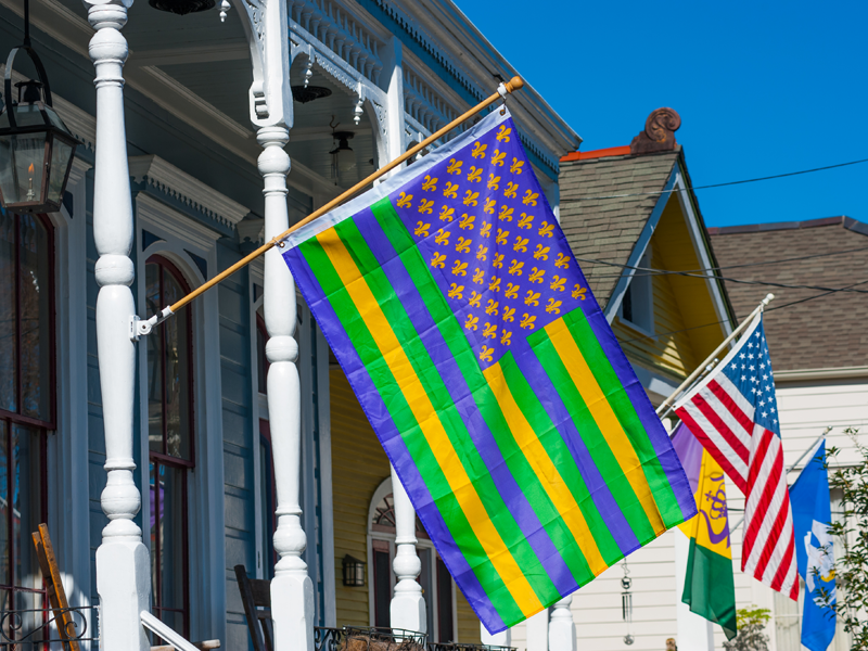 Colorful flags hang on New Orleans homes