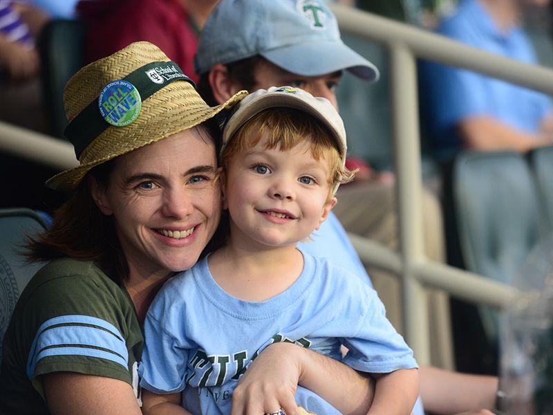 Mother and son enjoy a Tulane football game in Yulman Stadium