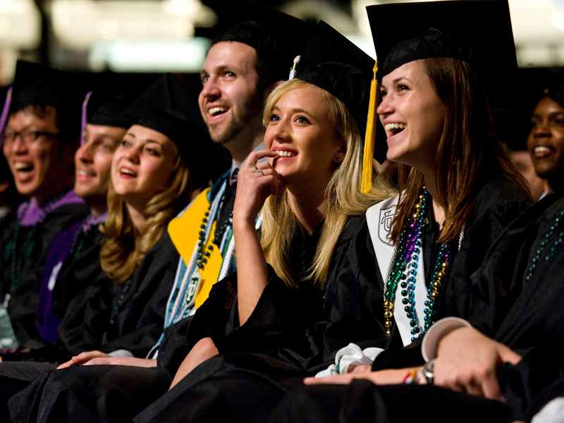 Graduates smile during the commencement ceremony