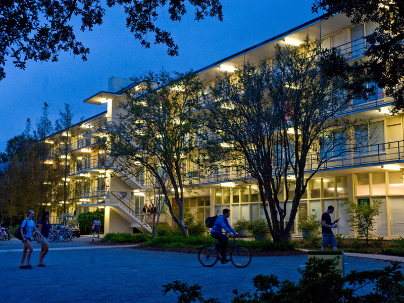 Students walk and bike past the Irby residence hall