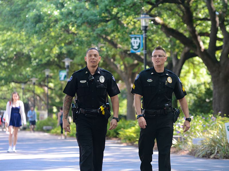 Tulane police officers walk down McAlister Place