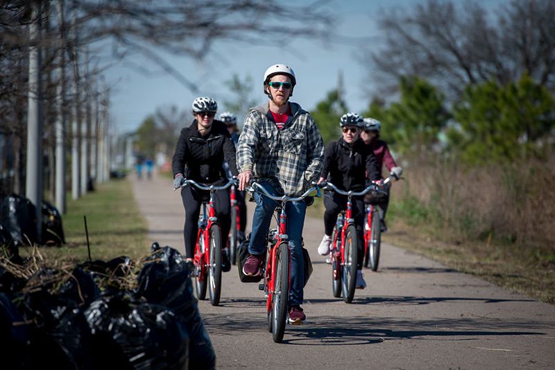 Bicyclists ride along the Lafitte Greenway
