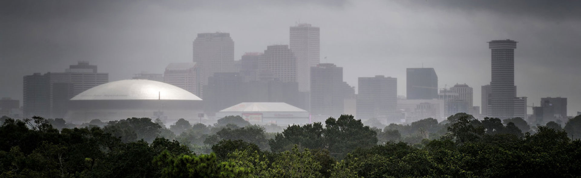 A dark and rainy New Orleans skyline during thunderstorm