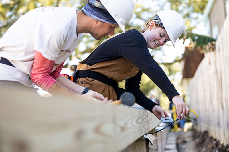 Two students work at an URBAN Build construction site