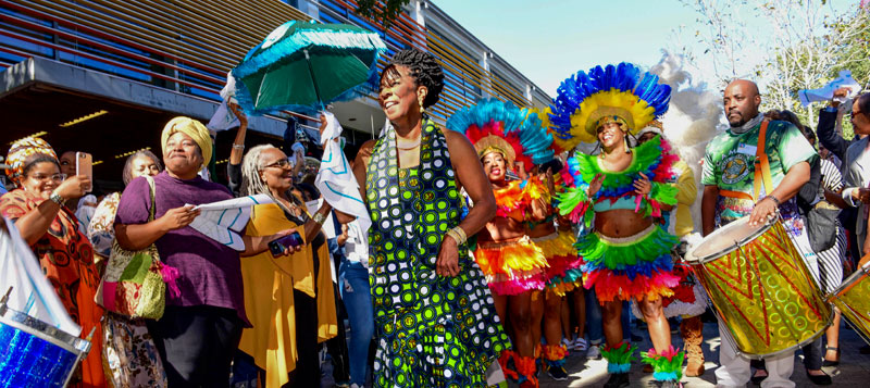 Carolyn Barber-Pierre second lines during uptown campus celebration