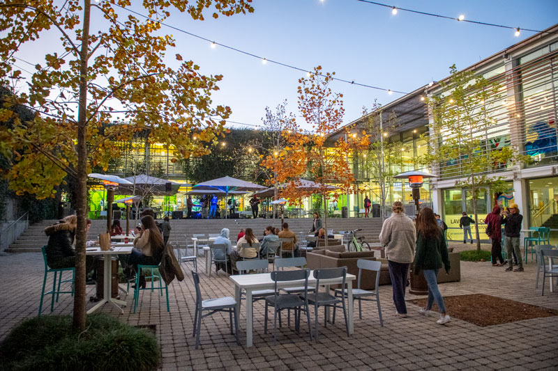 Students enjoy outdoor dining at the LBC at twilight