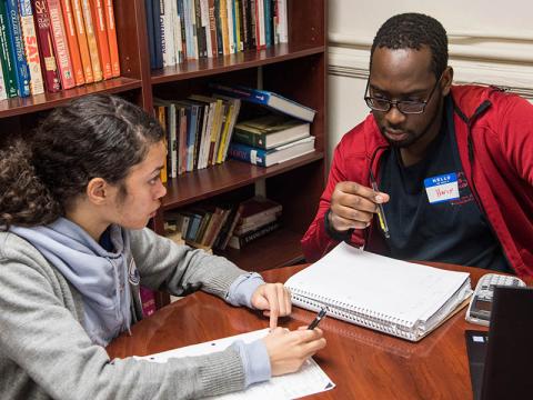 Two students help each other study.