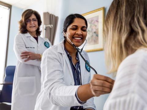 Doctor checks heart of patient using stethoscope