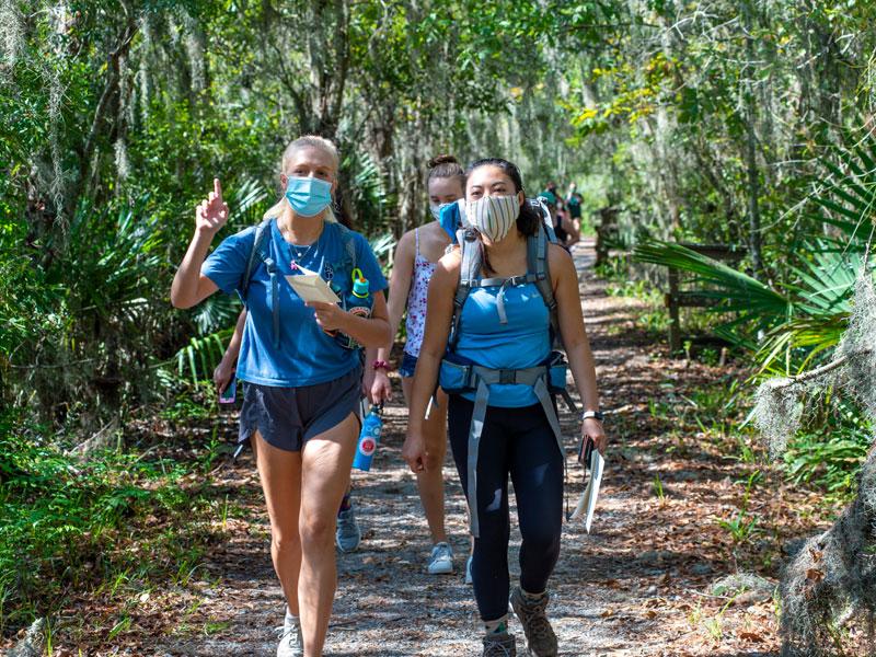 Eldridge (left) leads a Campus Recreation Outdoor Adventures hike in Barataria Preserve.