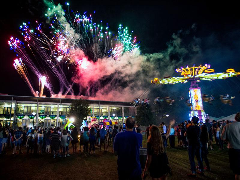 The Tulane community watches fireworks illuminate the night sky during Homecoming weekend